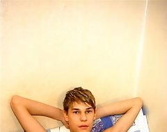 smooth lad shoves a huge dildo in his tight hole